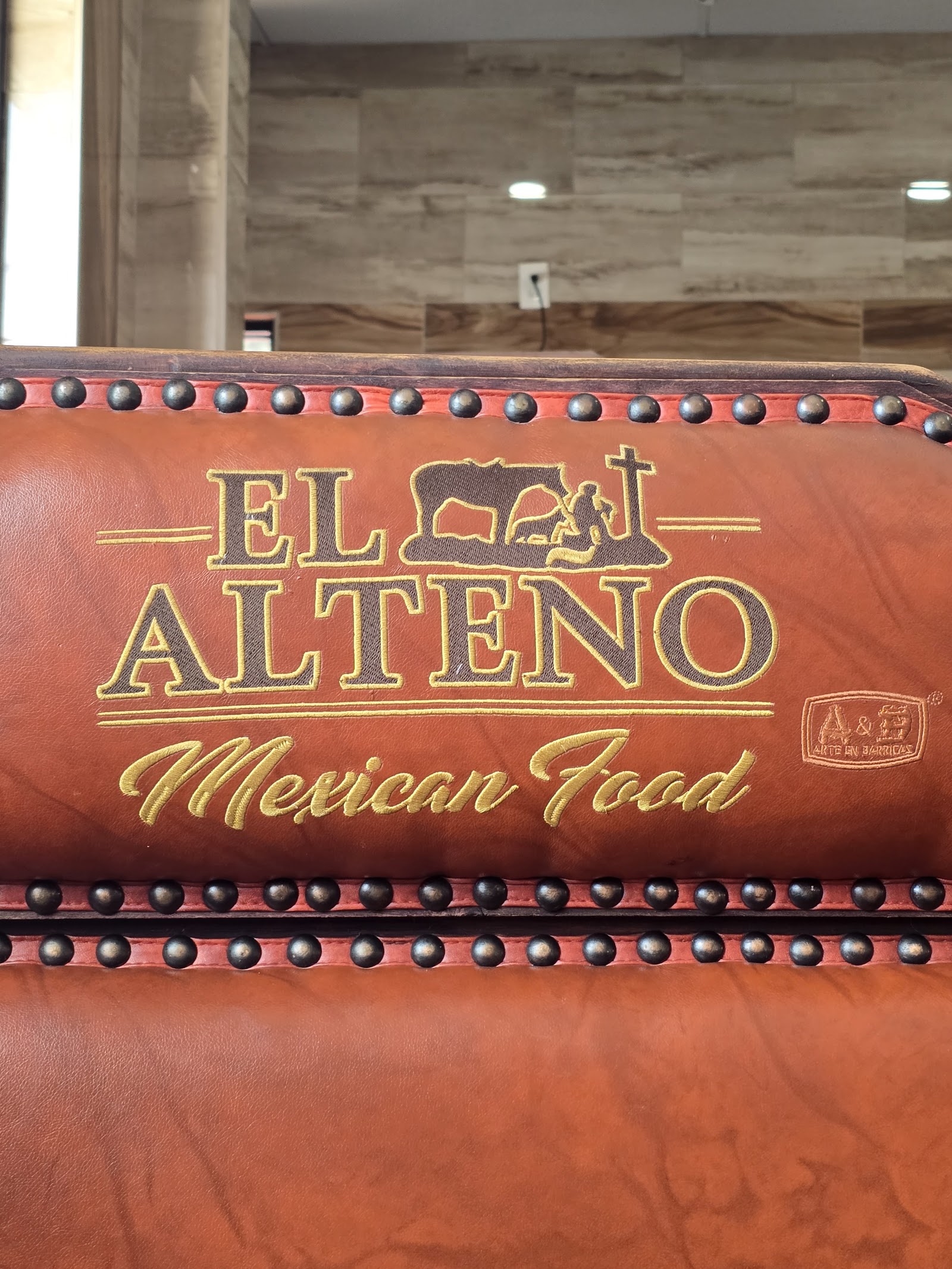 Close-up of El Alteño branded leather booth seating