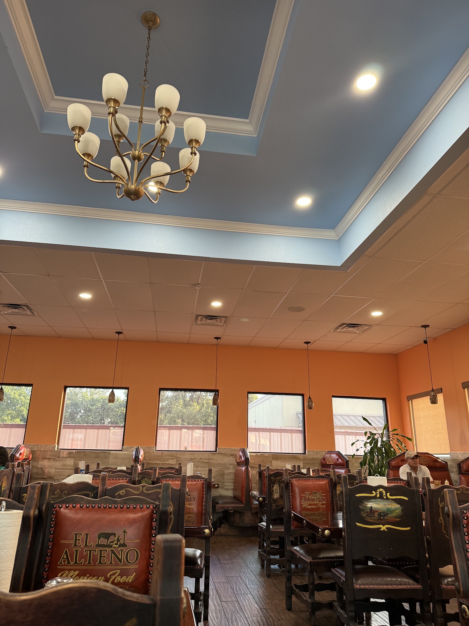 Interior dining room at El Alteño Mexican Food with leather chairs branded with the restaurant logo