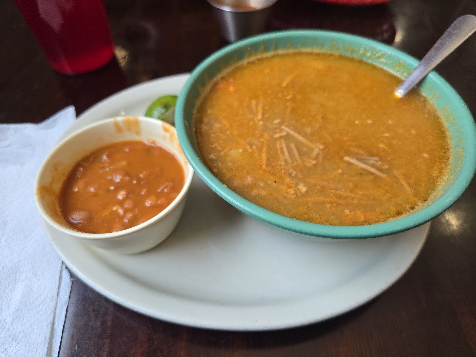 Bowl of fideo soup with a side of borracho beans